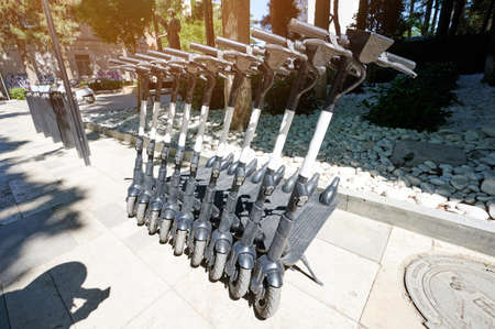 Electric scooter for rent parked in city street on one lineのeditorial素材