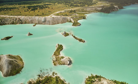 Green in big quarry water aerial drone view on bright sunny dayの写真素材