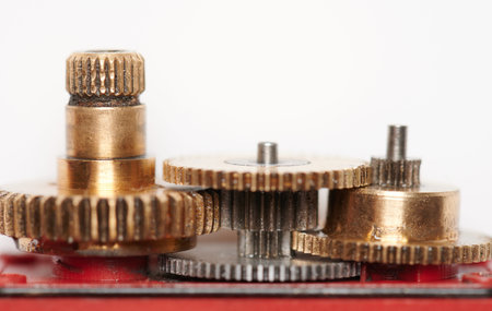 Mechanical gold color gears connection. Rotation mechanism close up view