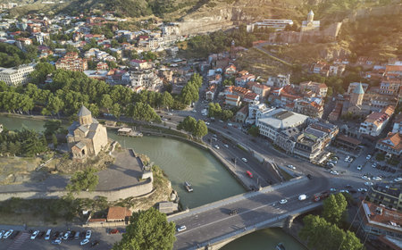 Church in center of Tbilisi town aerial drone view on sunset time