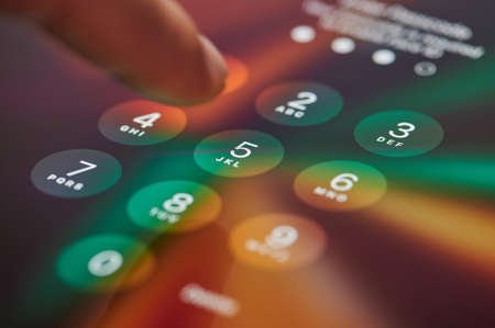 New york, USA - September 24 2021: Entering digital passcode on ipad panel screen close up viewのeditorial素材