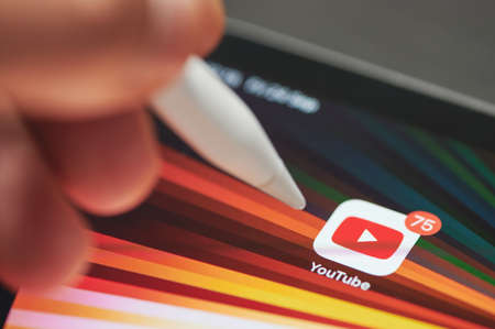 New york, USA - September 24 2021: Start Youtube on ipad panel screen close up view using penのeditorial素材