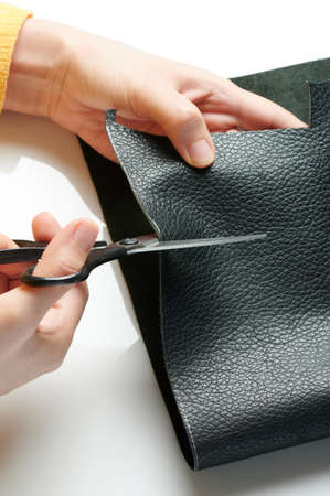 Working with quality leather slice. Tailor cutting genuine skinの写真素材