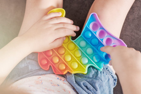 Small kid play popit close up hands on bubblesの写真素材