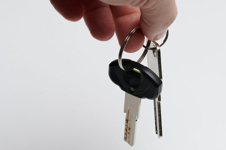 Real estate sale theme. Two metal keys hang on rings isolated