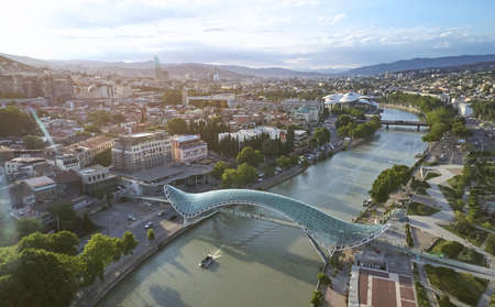 Tbilisi landscape with freedom bridge aerial drone view on summer timeの写真素材
