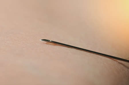 Syringe metal end for vaccination macro close up view on skin backgroundの写真素材