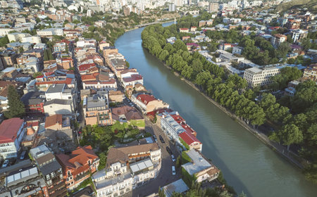 Historical center of Tbilisi on Kura river aerial drone view on bright day