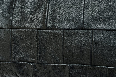 Pressed black leather pattern abstract background close up view