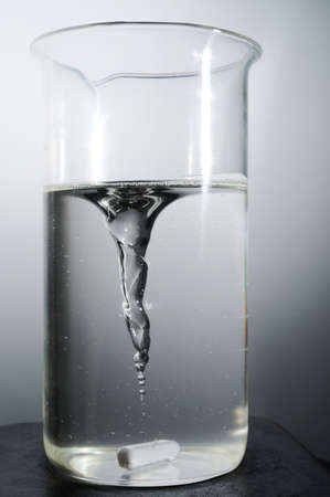 Glass flask with mixing wax liquid close up viewの写真素材