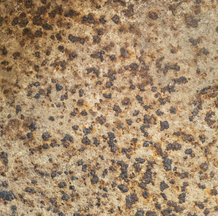 Rust on metal texture. Pattern dark black rusty spots on brown metal surface