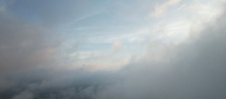 In middle of soft clouds on blue  sky aerial close up viewの写真素材