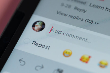New york, USA - October 11, 2022: Add new comment in social media on screen macro close up view backgroundのeditorial素材