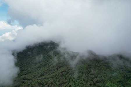 Fluffy clouds over Mombacho volcano in Nicaragua aerial drone view