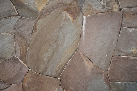 Cracked stone wall texture background close up view