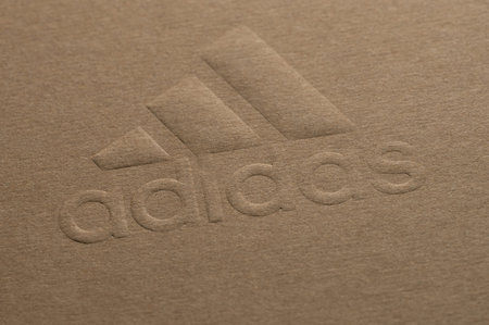 New york, USA - January 5, 2022: Adidas company logo on cardboard recycled box paper print close up...