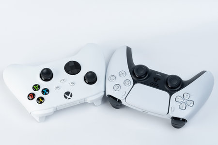 New york, USA - December 28, 2022: Two joysticks next to each other of Microsoft and Sony companiesのeditorial素材