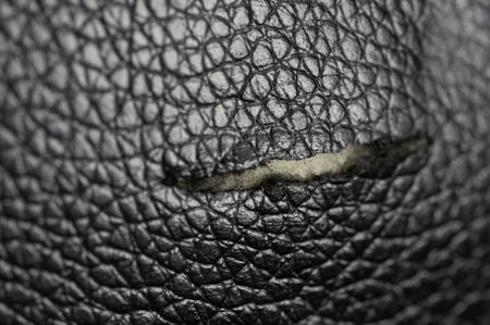 Ripped black leather material macro close up viewの写真素材
