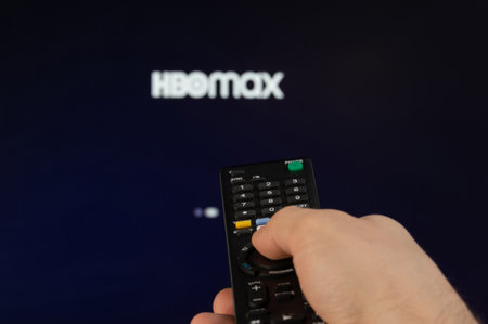 New york, USA - February 21, 2023: Play HBOMAX streaming platform on tv with remote control in handのeditorial素材