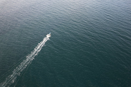 Fishing boat sail on sea water aerial drone viewの写真素材
