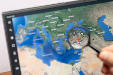 New York, USA - July 11, 2023: Zooming on Turkiye country through magnifying glass on screen of google earth close up viewのeditorial素材