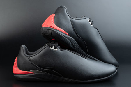 Black pair motosport shoes with flat sole isolated on studio background
