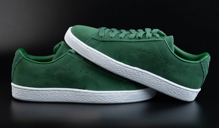 Green pair leather shoes with laces side view on black studio backgroundの写真素材