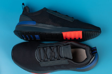 Pair athletic black shoes isolated on blue studio background