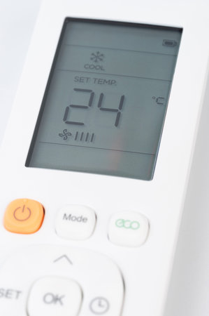 Set temperature on air conditioner with remote control buttons