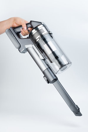 Small vacuum cleaner with narrow nozzle side view isolated on white studio backgroundの写真素材