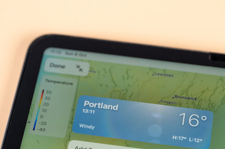 New York, USA - October 8, 2023: Checking temperature outside in Portland city on online app ipad tablet screen close up viewのeditorial素材