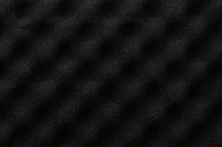 Black acoustic foam background with round 3d shapes