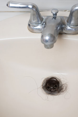 Cleaning sink plumbing hole from dark hole macro close up viewの写真素材