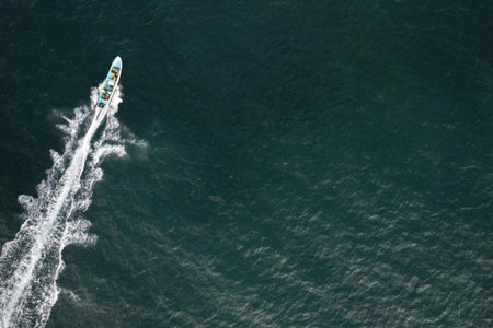 Fishing hobby theme. Going on small to catch fish in green sea aerial veiwの写真素材