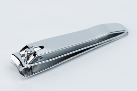 Closed nail clippers close up isolated on white studio backgroundの写真素材