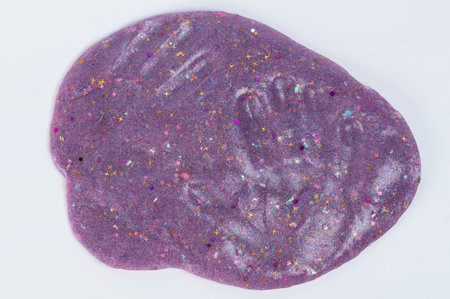 Hand shape from child on slime purple backgroundの写真素材