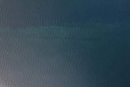 Texture of blue shallow sea water above top drone viewの写真素材