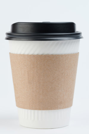 One clean paper cup with lid and sleeve front view isolatedの写真素材