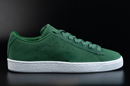 One green casual shoe with laces side view on black studio backgroundの写真素材