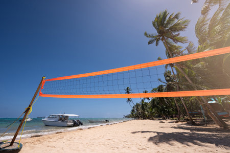 Volleyball activity on Caribbean sea beach theme. Yellow volley net on blue skyの写真素材