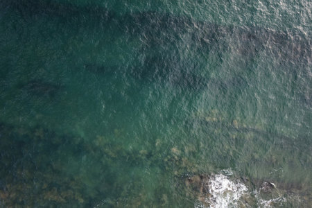 Beautiful green sea water background. Texture of shiny wavesの写真素材