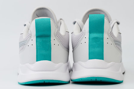 Rear view of white with green shoes close up view
