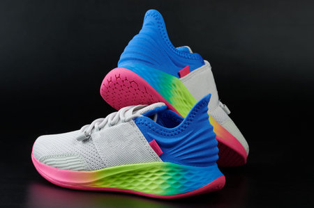 Rainbow color running shoes isolated on black studio background