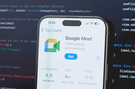 New York, USA - February 23, 2024: Google meet  on iphone screen in blurred code programming backgroundのeditorial素材