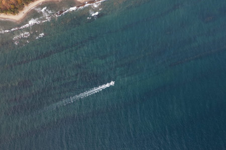 Fishing boat move next shallow beach above top view