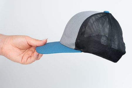 Hand hold blue cap side view isolated close up view