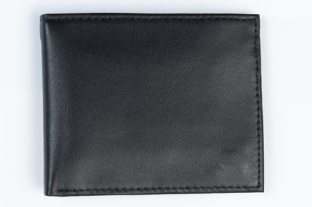 Closed wallet from black leather front view isolated on white studio backgroundの写真素材
