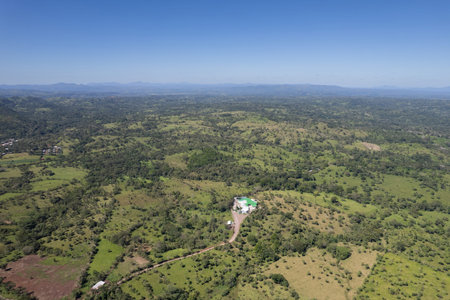 Modern farm in green mountain landscape aerial drone view