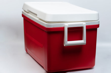 Portable plastic closed fridge side view isolated on studio background