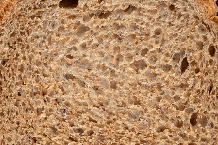 Whole grain bread brown texture with seeds macro close up viewの写真素材
